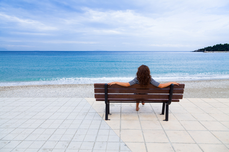 Woman enjoing the beautiful view of the Mediterranean in Poros, Kefalonia, Greece.の写真素材