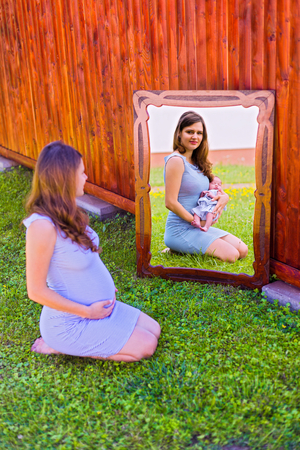 Pregnancy and new life concept - beautiful mother before and after giving birth.の写真素材