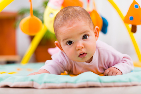 Beautiful little baby looking to the camera attentively.の写真素材