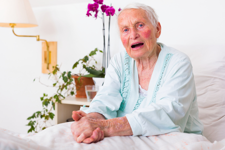 Elderly woman telling her problems to the listener. Sickness is hard at this age.の写真素材