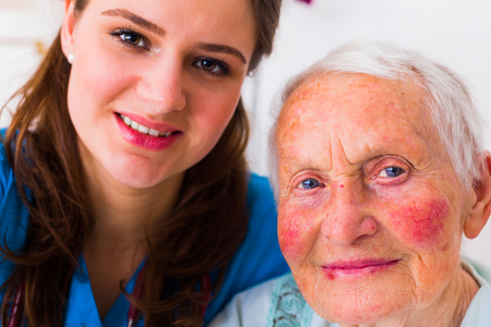 Nurse and elderly patient taking a selfie to send it to the relatives to show that everything is going well.の写真素材
