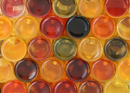 Back view of colorful, stacked bottlesの写真素材