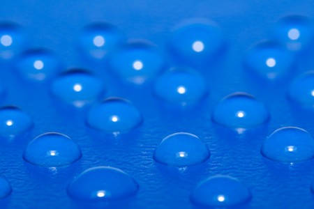 Multiple waterdrops on blue surface - macro, shallow depth of fieldの写真素材