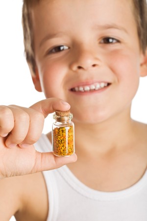 Little boy holding small bottle of pollen - natural remedies conceptの写真素材