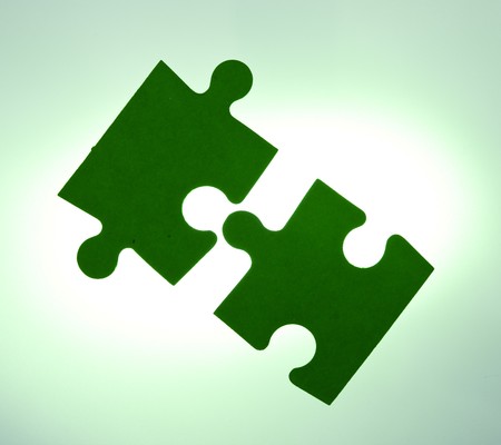 Backlit green puzzle pieces closeup - solution conceptの写真素材