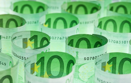 Rolled hundred euro banknotes green money backgroundの写真素材