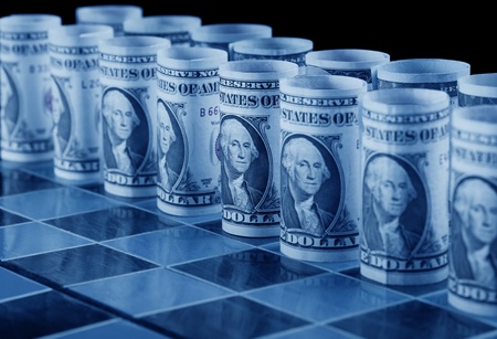 Money strategy concept with dollars as pieces on chess board - in cold blue shadesの写真素材