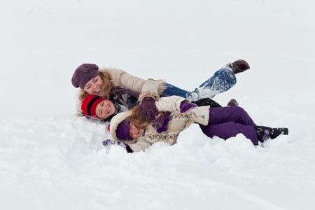 Woman and kids having fun in the snowの写真素材