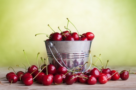 Lots of fresh and juicy cherries on old tableの写真素材