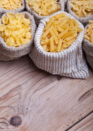 Assorted pasta variety in burlap bags - with copy spaceの写真素材