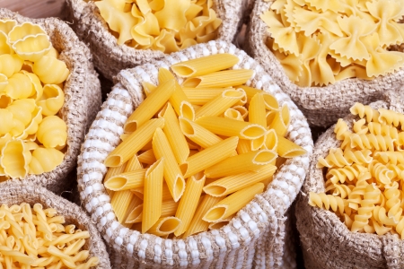 Assorted pasta in burlap bags - top view, closeupの写真素材