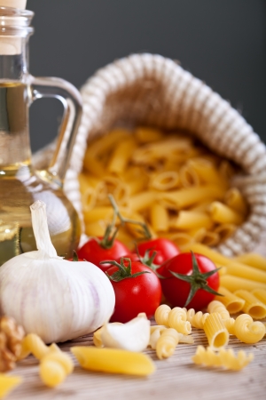 Italian cuisine typical ingredients - pasta, garlic and tomatoの写真素材