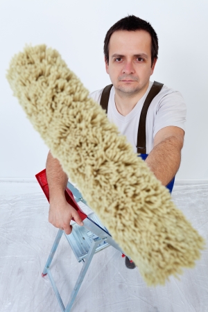 Painter holding painting roller - top viewの写真素材
