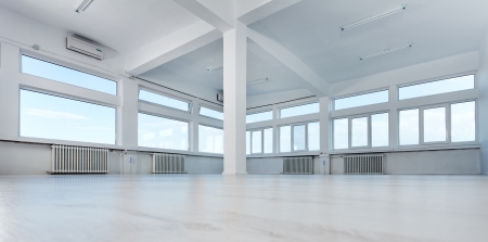 Empty office space with large windowsの写真素材