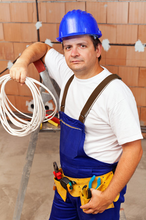 Electrician in a new buildingready to install electrical wiresの写真素材