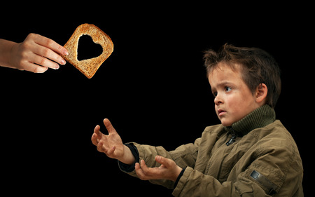 Giving food to the needy - sharing with the less fortunateの写真素材