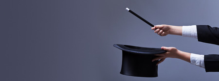 Magician hands with hat and magic wand - with copy spaceの写真素材