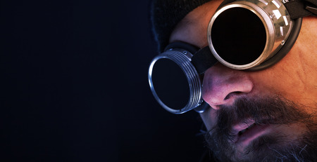 Shag beard and mustache man with goggles overlooking copy spaceの写真素材