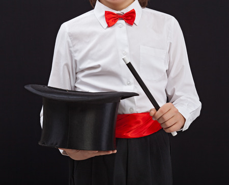 Magician detail - closeup on magic hat and wand in child handsの写真素材