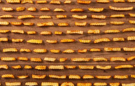 French fries in rows - food background