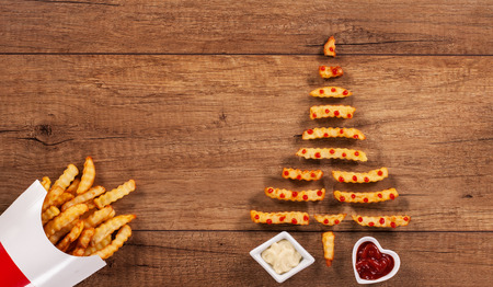 Merry christmas with french fries fast food xmas tree having ketchup drops decoration - copy spaceの写真素材