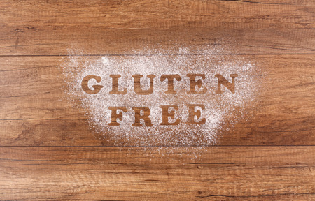 Gluten free written in flour on brown table - top view, copy spaceの写真素材