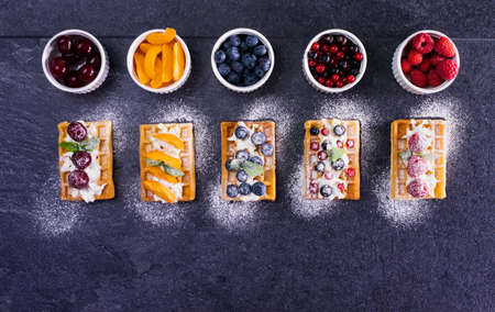 Waffles with seasonal summer fruits for dessert - top down view, copy spaceの写真素材