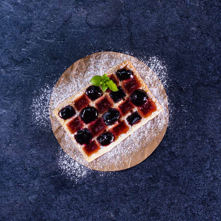 Waffle with blueberry and red currant jam, summer dessert - top view, close up, copy spaceの写真素材