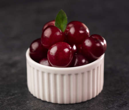 Fresh sour cherries in small recipient - delicious summer fruits