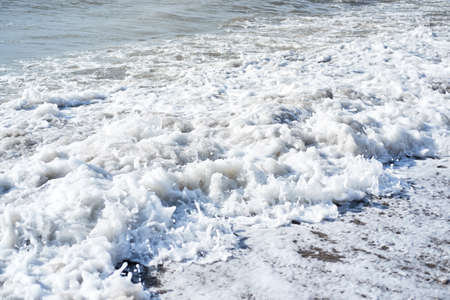 White bubbling foam of sea, side view. Beautiful textured sea fresh cold water, horizontal ocean...