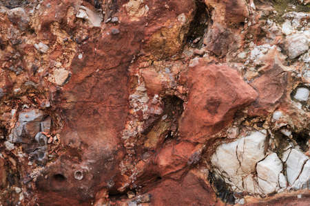 Unusual beautiful orange stone texture. Minimalistic geological background for desktop or advertising. Light yellow stone on rock close up. Rock of attractive shade and bulge.の写真素材
