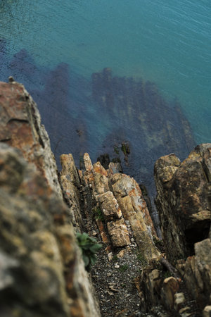 View from a high cliff to the blue turquoise clear sea and coral reefs under the water. Gorgeous...