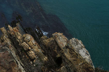 View from a high cliff to the blue turquoise clear sea and coral reefs under the water. Gorgeous...