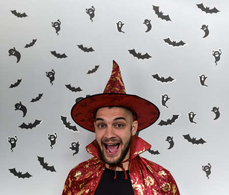 Minimalistic banner celebrating Halloween with bearded Caucasian man in witch costume and black...
