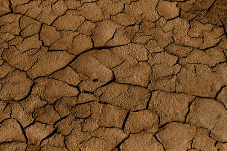Cracks in the sand. Orange sand in the desert cracked in dry weather. Minimalistic background top...