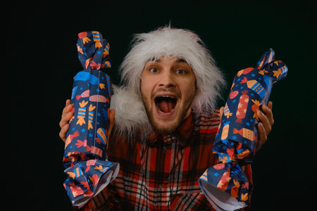 Concept of New Year and Christmas. Minimalistic festive studio background with person. Young...