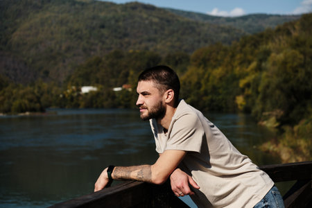 Young man travels to the Balkan countries in early autumn. The Drina River flows on the border of...