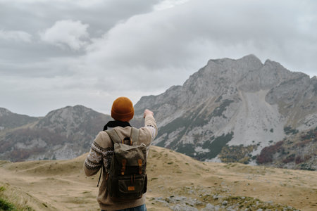 Traveler young man outdoor. Montenegro country, Durmitor National Park. Saddle Pass in autumn...