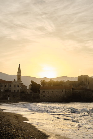 View of the old town with fortress and citadel at dawn. The coast of the Adriatic Sea. Budva, Montenegro in the morning sunの写真素材
