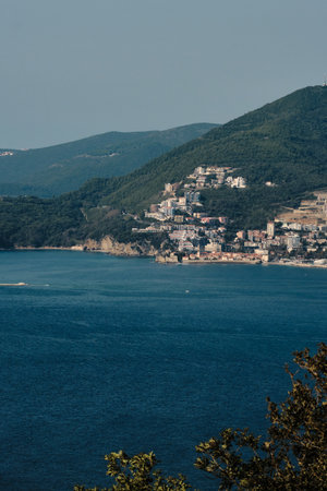 Coastal city built along the slopes of a lush green mountain. Modern buildings blend with history architecture of old town Budva near the shoreline. Picturesque landscape. Montenegro countryの写真素材