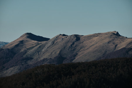 Sunlit mountain ridges stretch under a clear sky in the Komovi range, Montenegro, capturing the wild beauty of the Balkans in late autumn.の写真素材