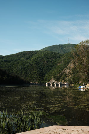 Hydroelectric dam with lush mountains reflected in the river. Zapadna Morava lake in Serbia countryの写真素材