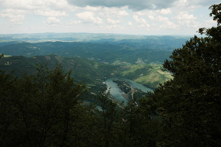 Scenic view of the Morava River meandering through lush green hills from Ovcar mountain, Serbia in spring seasonの写真素材
