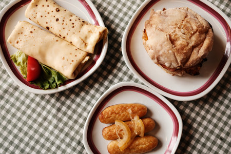 Traditional Balkan breakfast with pancakes, dessert kalach and bread sandwich with meat, cheese and vegetables. Top viewの写真素材