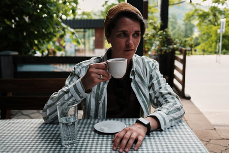 Woman enjoying a cup of strong Serbian coffee at an outdoor cafe in Tara National Park