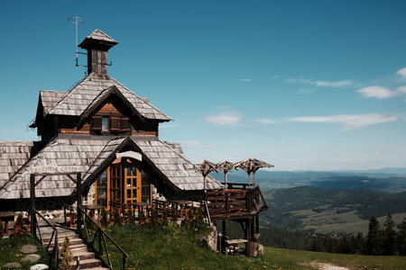 Wooden mountain cafe with a panoramic terrace overlooking the green hills of Zlatibor, Serbia in...