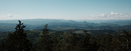 Vast mountain range view from Tornik peak in Zlatibor, Serbia country with layered hills stretching...