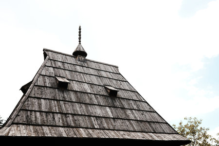 Detailed wooden rooftop of a traditional house in Serbia ethnovillage with carved ornamentsの写真素材