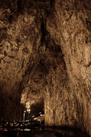 Illuminated cave walls with dramatic rocky textures inside Stopica Cave, Zlatibor, Serbia. A popular place among touristsの写真素材