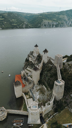 Aerial view of Golubac Fortress on rocky cliff above the Danube River in Serbia, surrounded by water and medieval towers. The most popular and beautiful fortress in Serbia on the border with Romaniaの写真素材